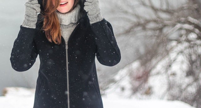 Person wearing a large coat in the snow 