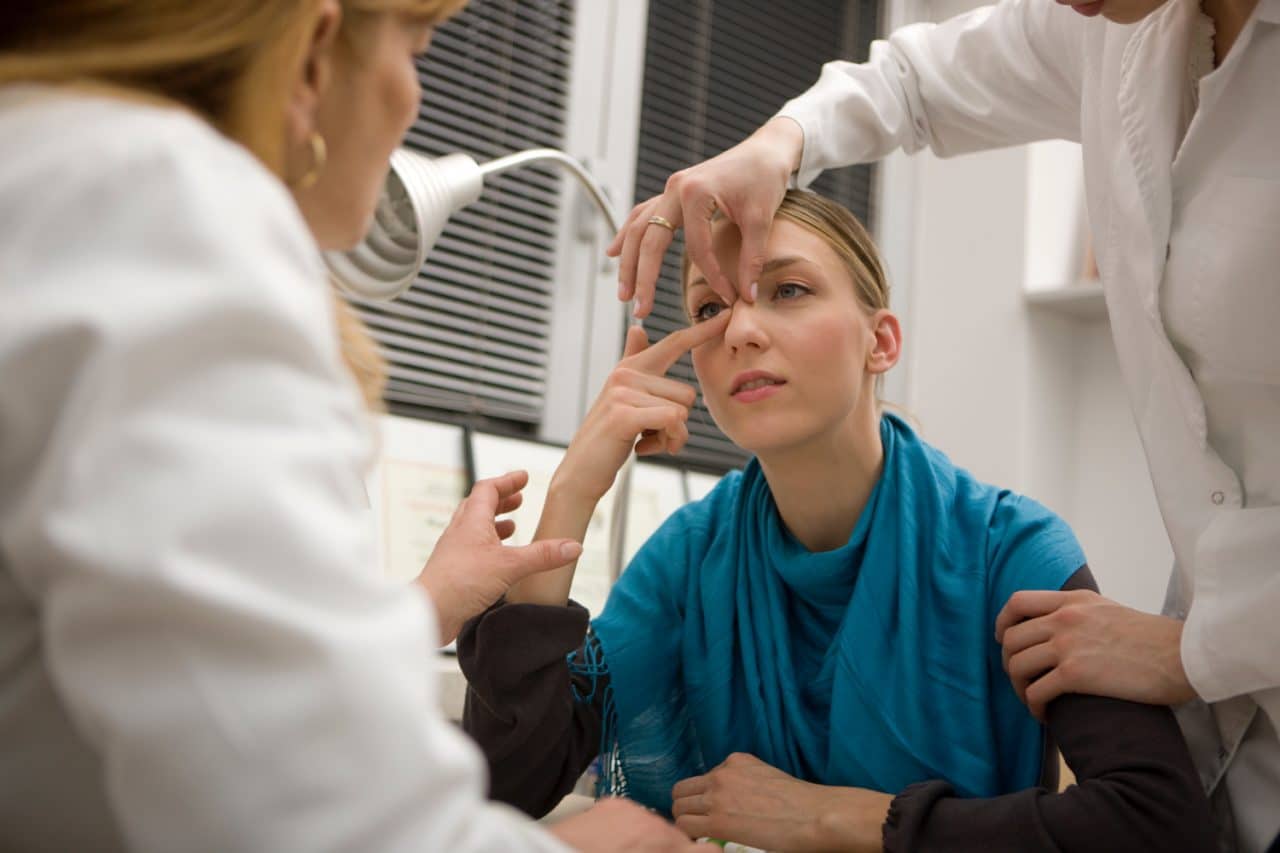 Woman being examined by doctors for Rhinoplasty surgery
