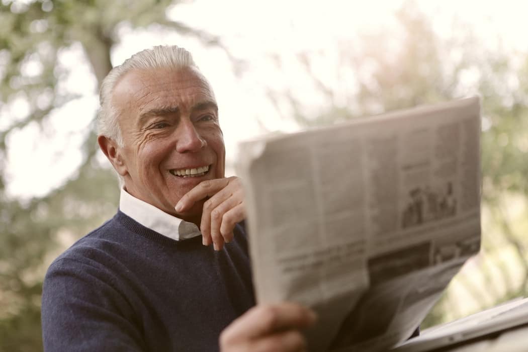 Man reads newspaper.