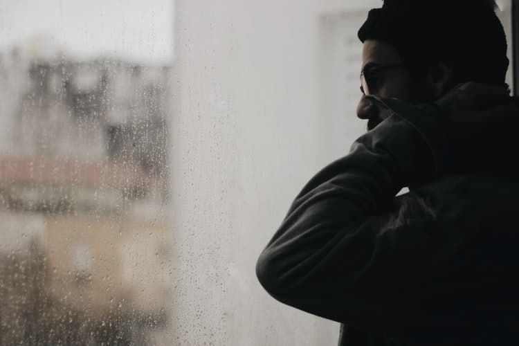 Man looking through window.