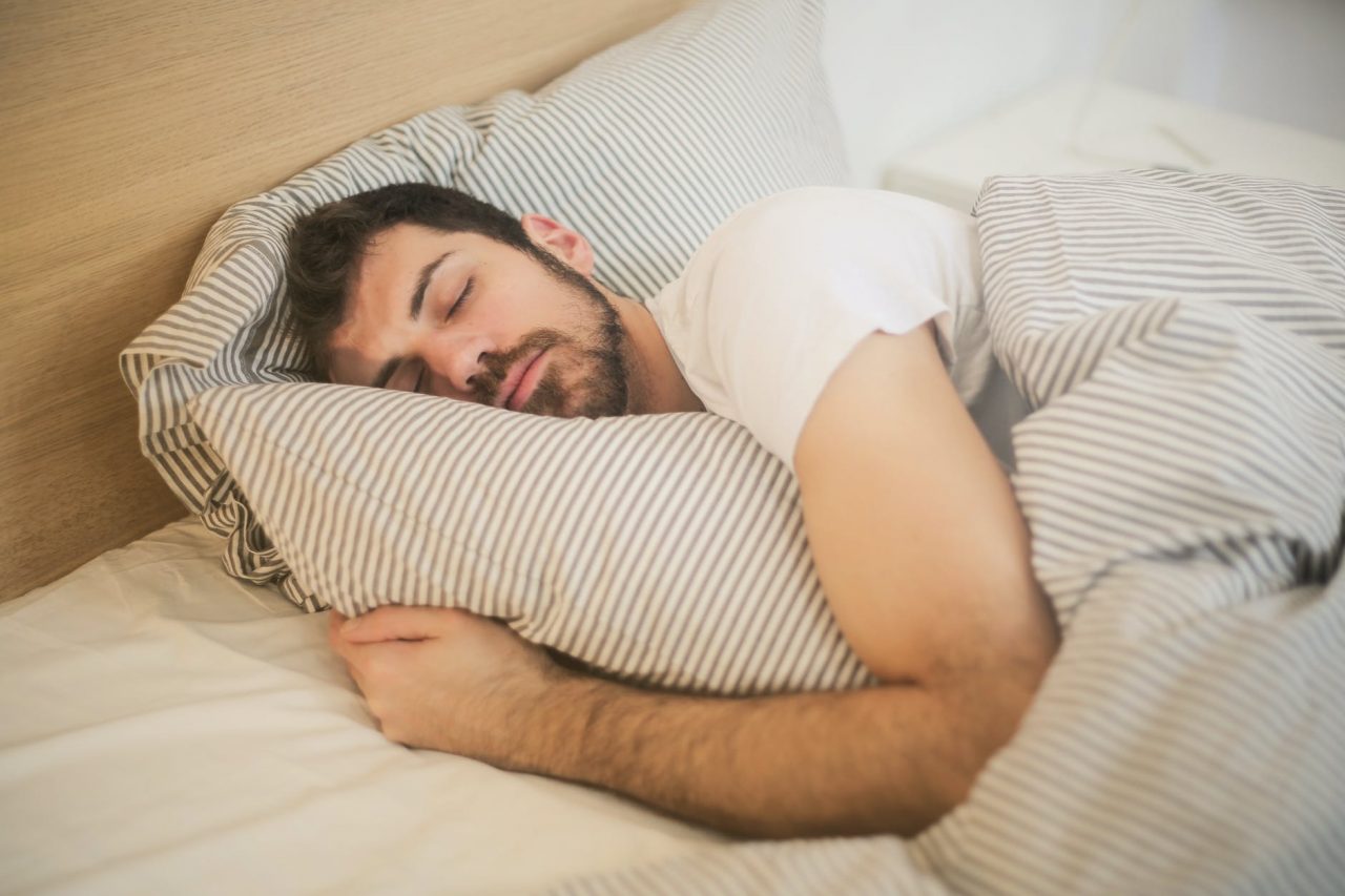 Man sleeping with pillow.