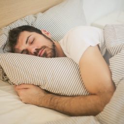 Man sleeping with pillow.