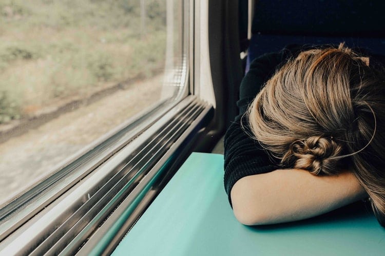 Woman falls asleep on train.