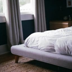 A mattress on a bed frame.