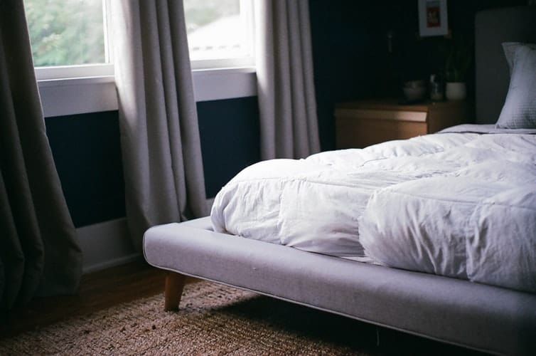 A mattress on a bed frame.