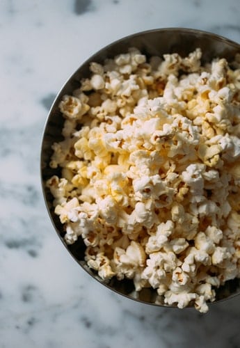 A bowl of popcorn on a table.