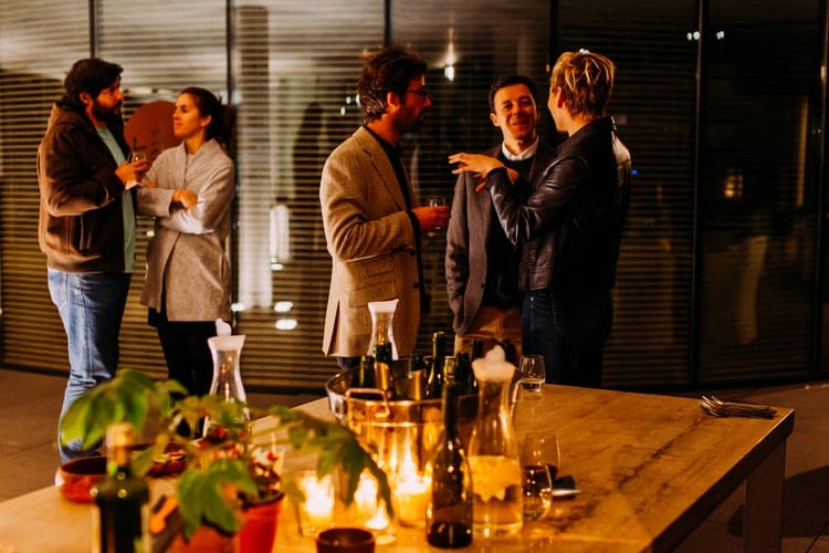 A group of people together at an indoor dinner party.