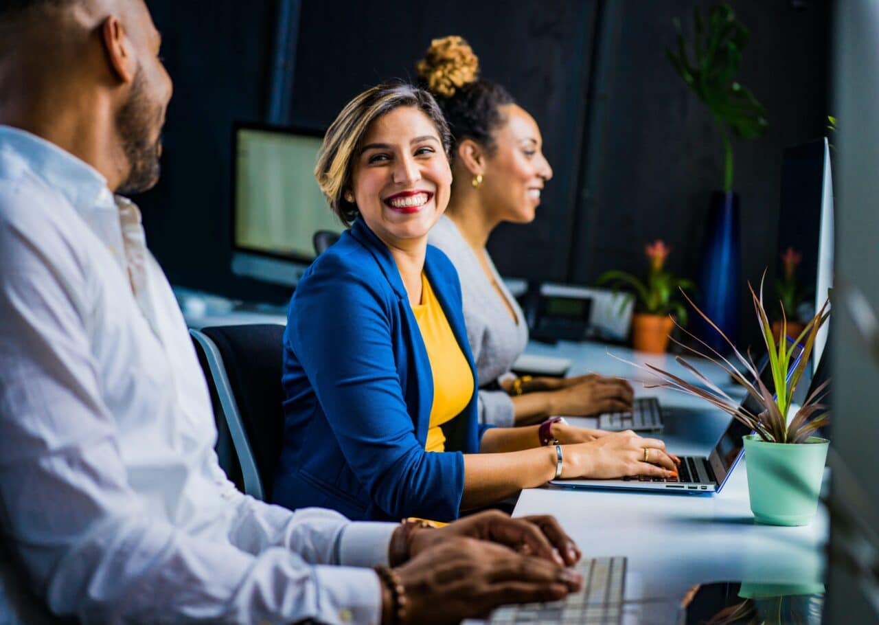 Woman at work chatting with her coworkers.