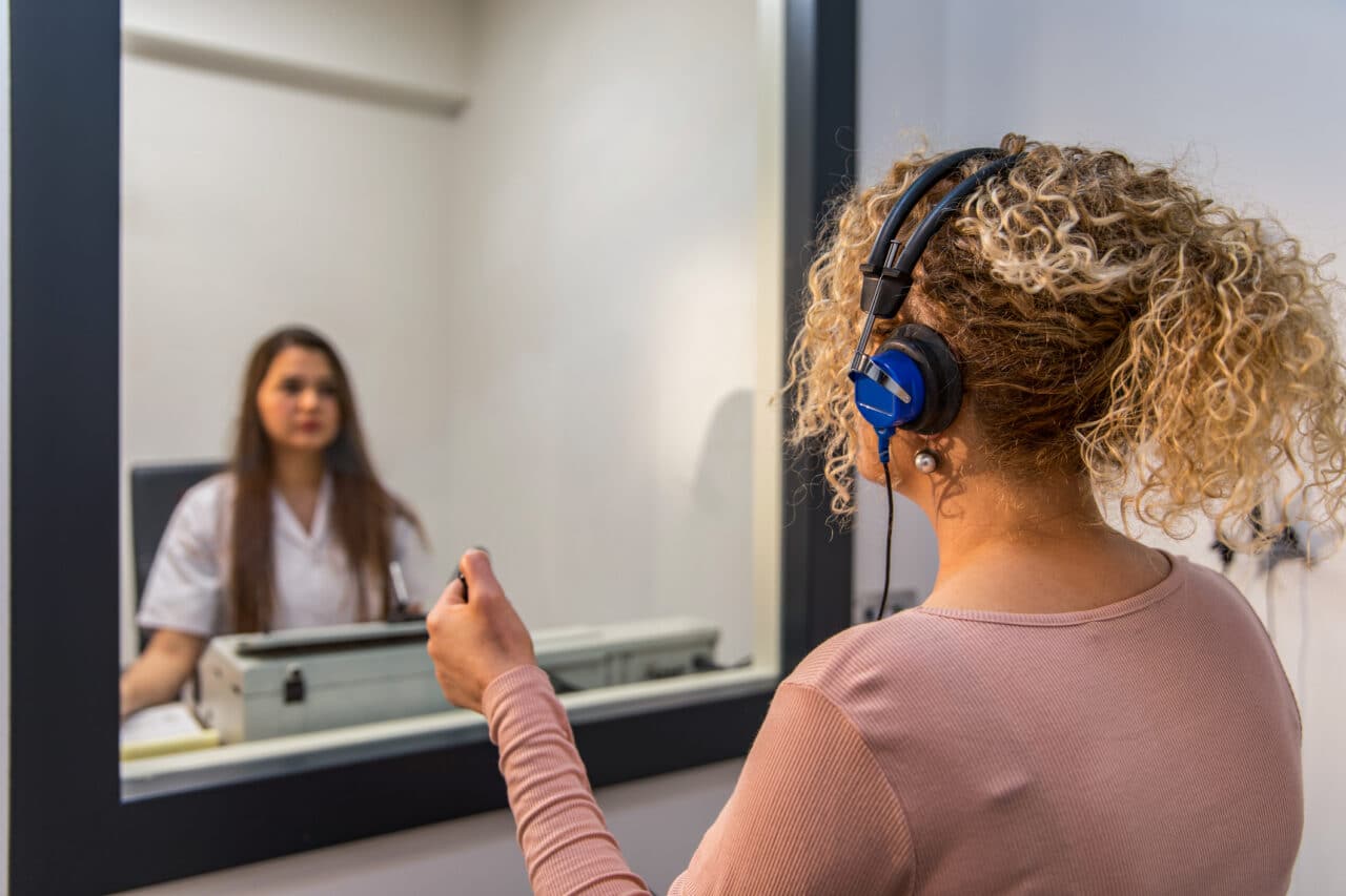 Young woman receiving a hearing test.