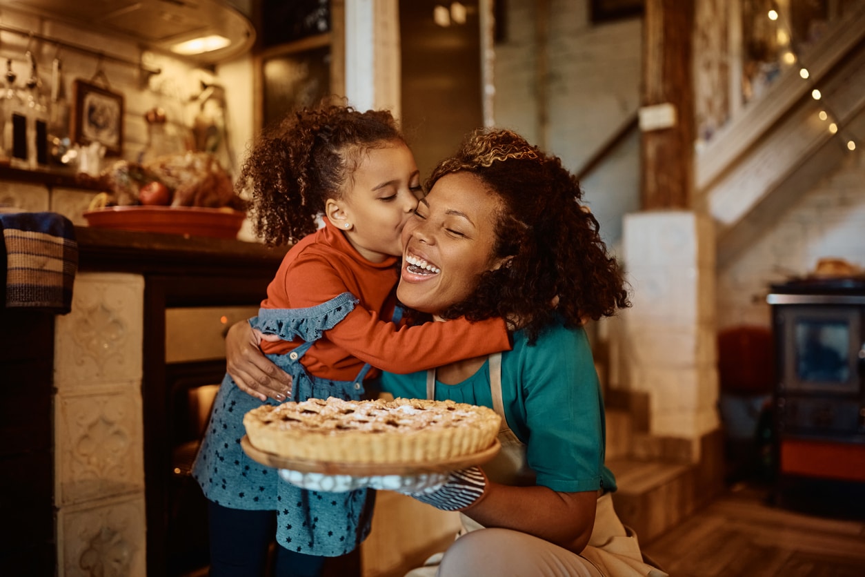 Happy mother and daughter with a holiday pie.