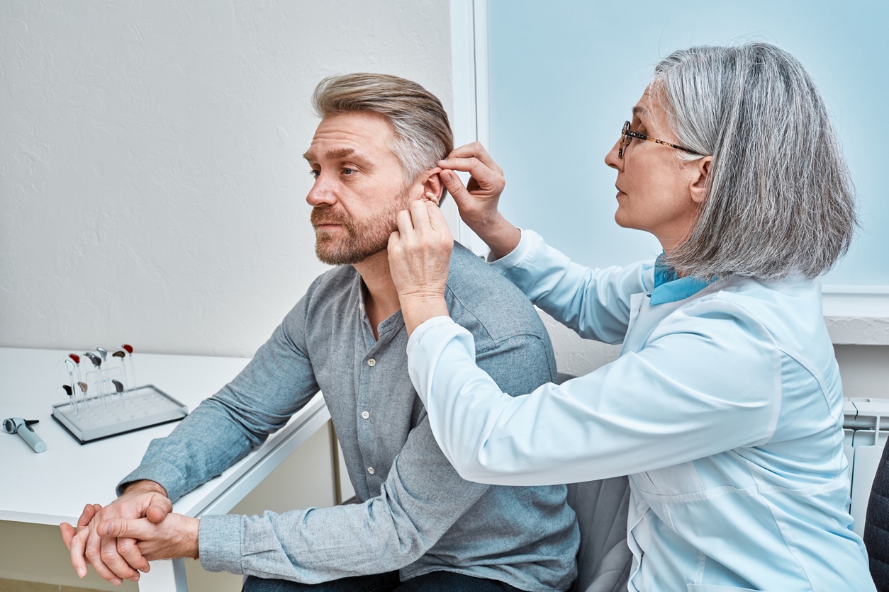 Man is fitted for hearing aids