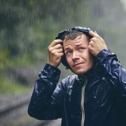 Man wearing a rain jacket in the pouring rain