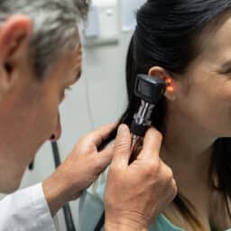 ENT checking a woman's ear for blockages