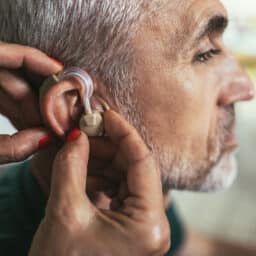 Senior man getting his new hearing aid