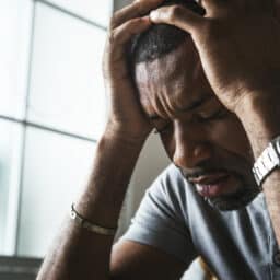 Frustrated man holding his head in his hands