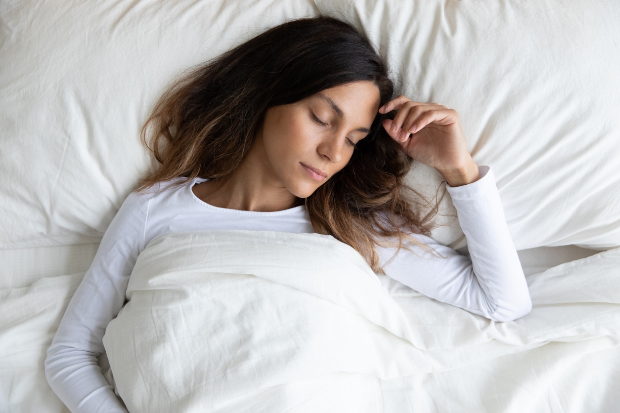 Young woman sleeping in bed