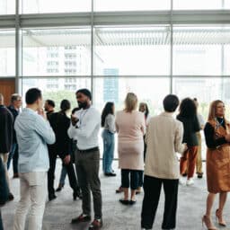 Small crowd of people standing in an office